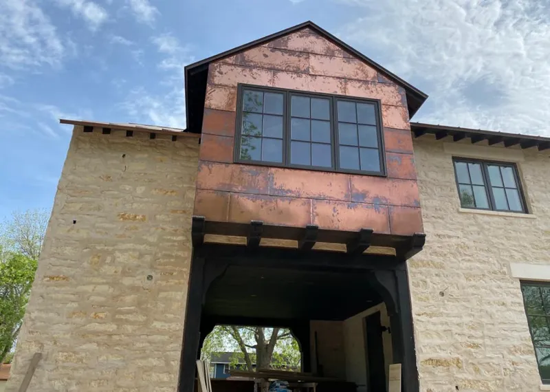 Copper metal panel facade on a stone building for Roof Repair in Green Valley
